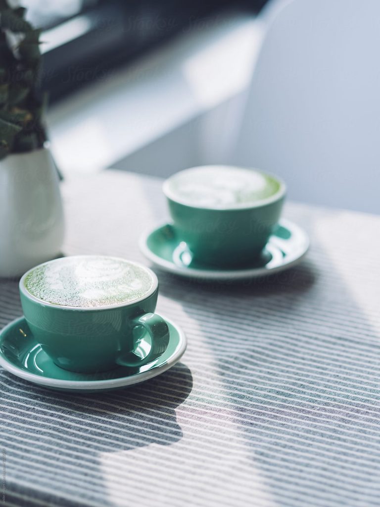 two cups of coffee or tea in mint green mugs